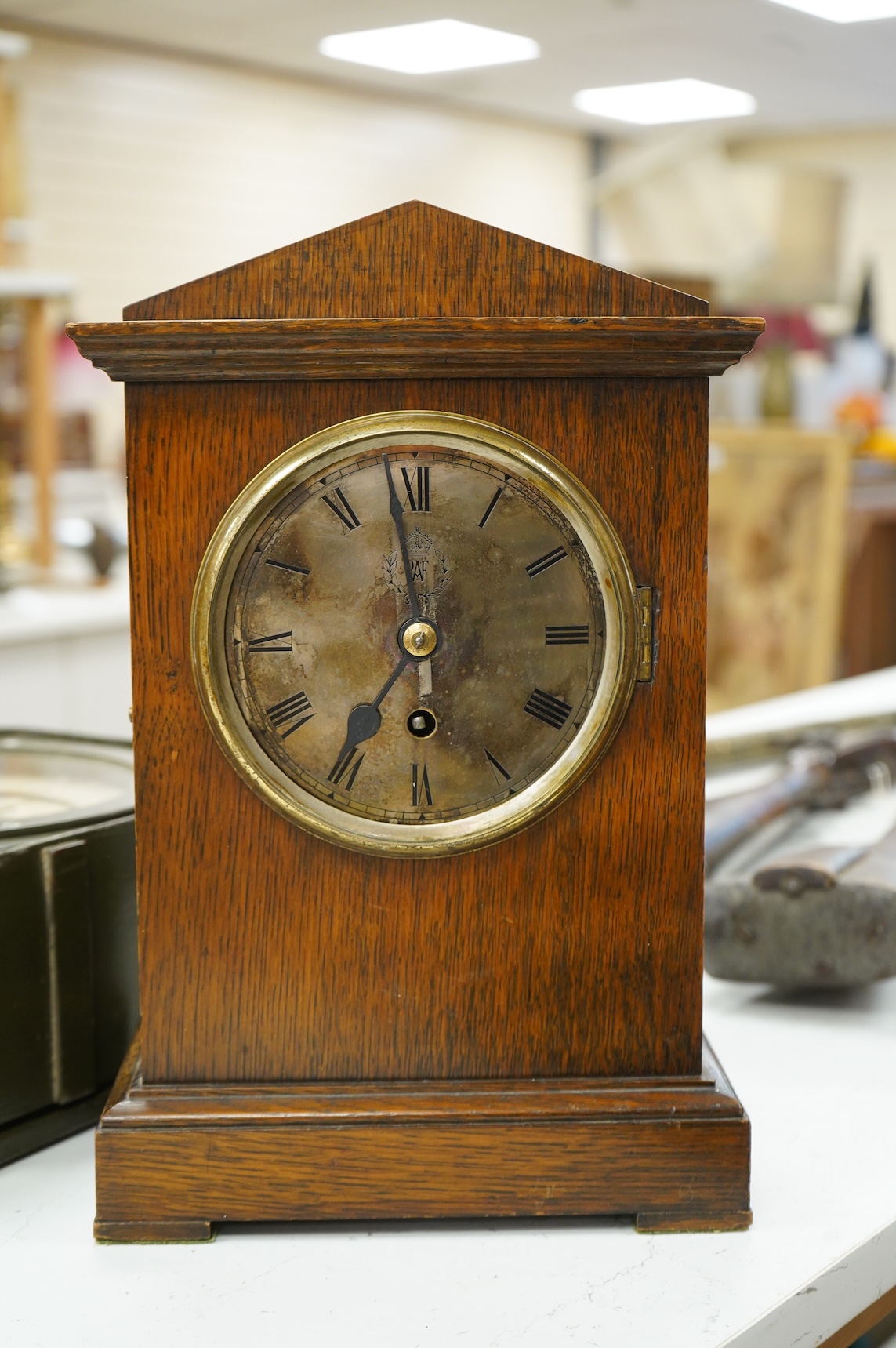 A RAF oak cased Officer's Mess mantel timepiece, with winding key, case key and pendulum, silvered dial engraved with crowned RAF surrounded by laurel insignia, and an 8 day fusee movement by F.W. Elliott, dated 1938, 35